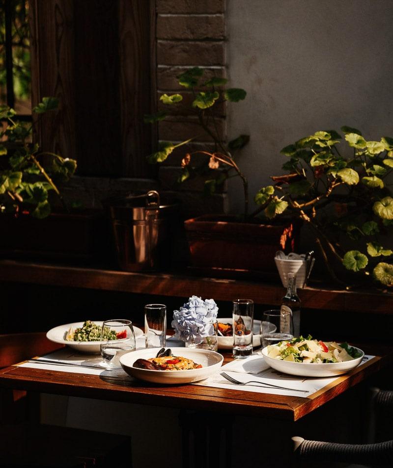A table with risotto, salads and wine